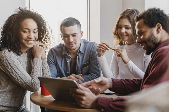 Group of people accessing online meeting platform via tablet